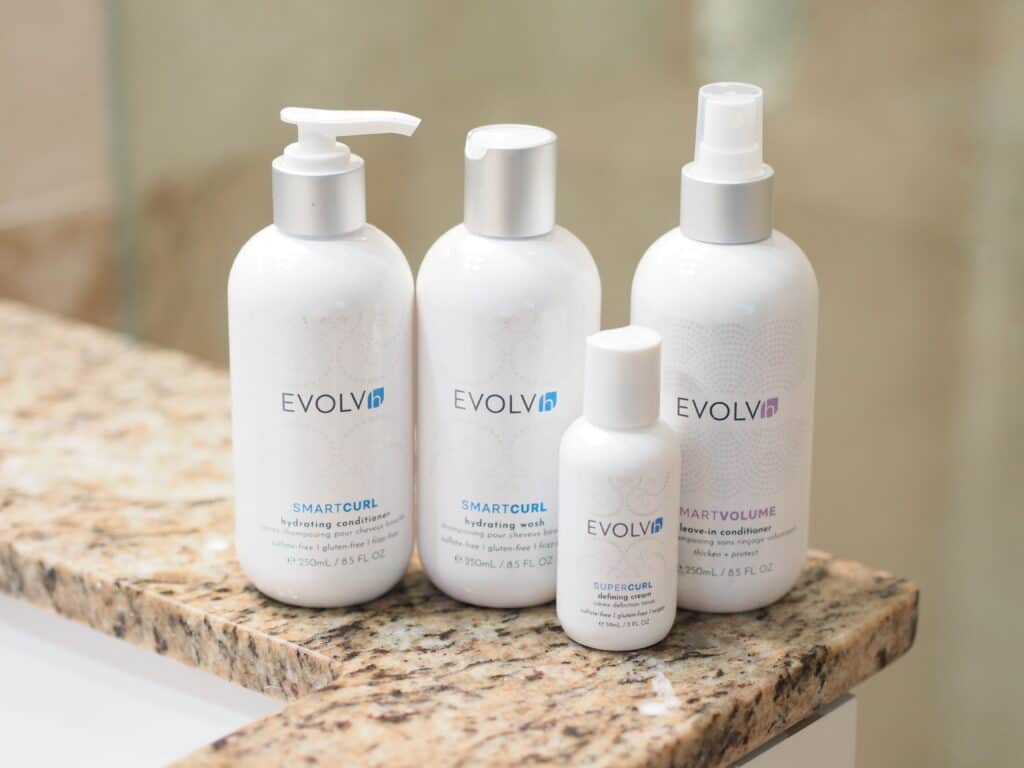 products for fine curly hair EVOLVh smart curl line in bathroom sink in a row